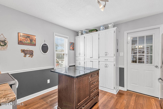 kitchen with white cabinets, dark brown cabinetry, a textured ceiling, and dark hardwood / wood-style flooring