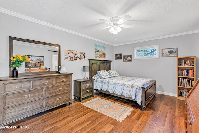 bedroom with ceiling fan, a textured ceiling, wood-type flooring, and ornamental molding