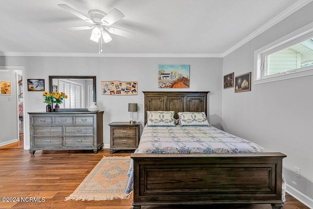 bedroom featuring crown molding, dark hardwood / wood-style floors, and ceiling fan