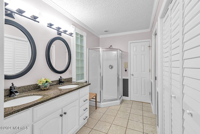 bathroom with a shower with door, crown molding, vanity, and tile patterned flooring