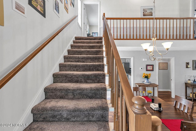 stairs with a notable chandelier and wood-type flooring