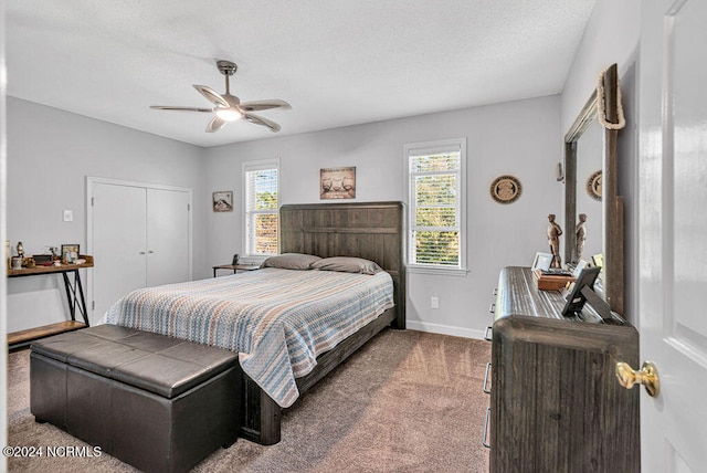 bedroom with carpet, a textured ceiling, a closet, and ceiling fan