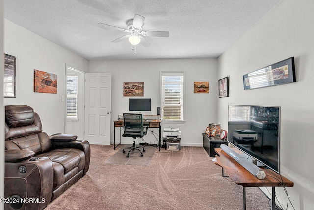 carpeted office space featuring a textured ceiling and ceiling fan