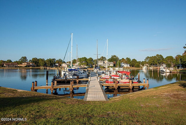 dock area with a yard and a water view