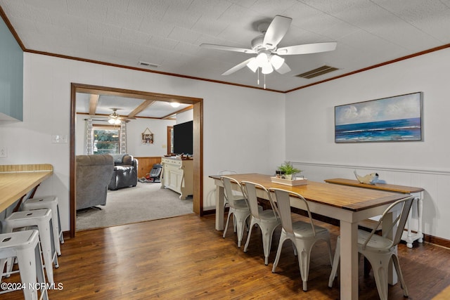 dining area with ornamental molding, ceiling fan, a textured ceiling, and dark hardwood / wood-style flooring