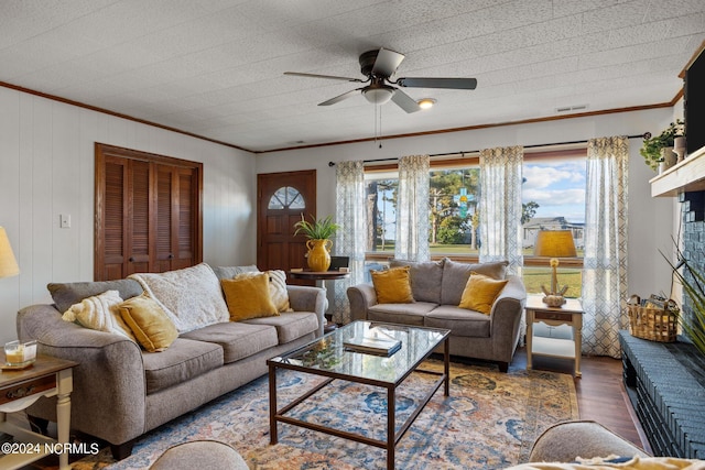 living room with ornamental molding, ceiling fan, a healthy amount of sunlight, and dark hardwood / wood-style flooring