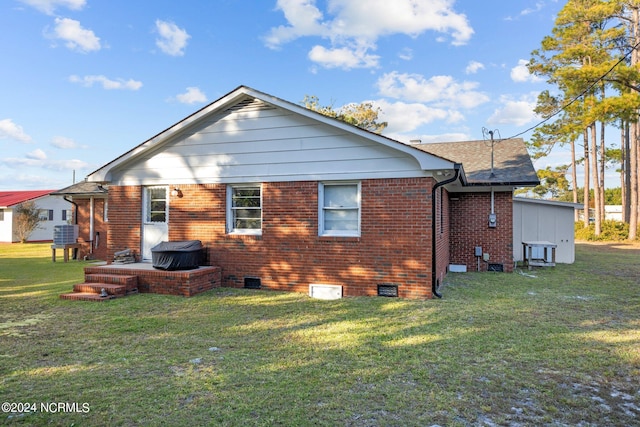 rear view of property with a yard