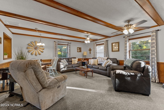 carpeted living room featuring beam ceiling, a healthy amount of sunlight, a textured ceiling, and ceiling fan with notable chandelier