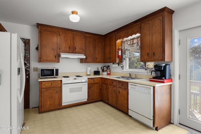 kitchen with sink and white appliances