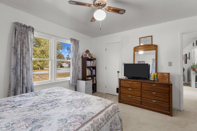 bedroom featuring light colored carpet and ceiling fan