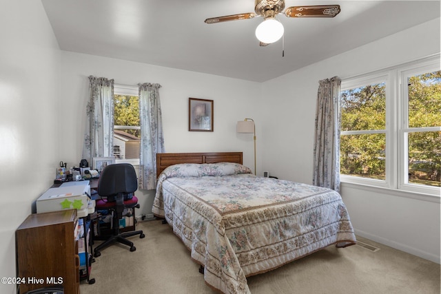 bedroom with light colored carpet and ceiling fan