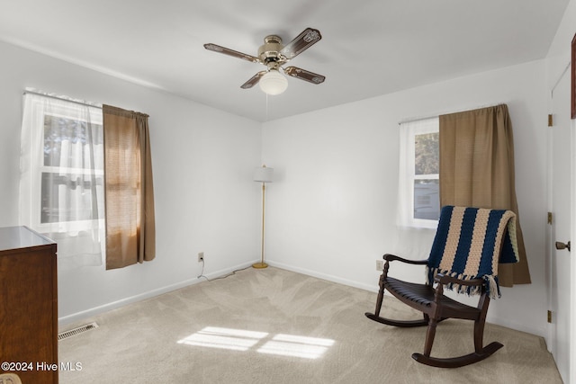 sitting room with light carpet, a healthy amount of sunlight, and ceiling fan