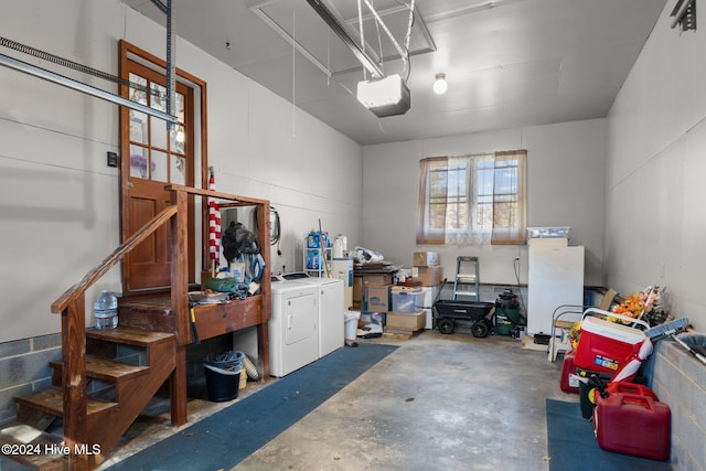 garage featuring a garage door opener and separate washer and dryer