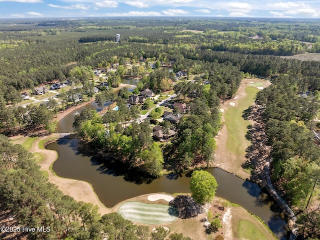 drone / aerial view with view of golf course, a forest view, a water view, and a residential view