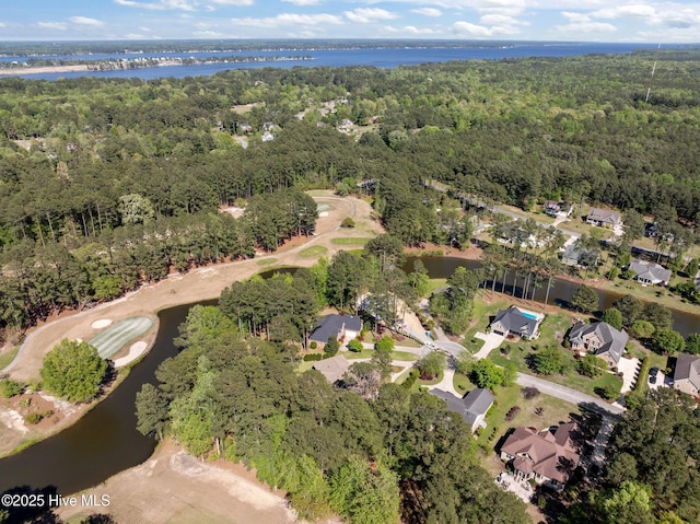 drone / aerial view with a residential view, a forest view, and a water view