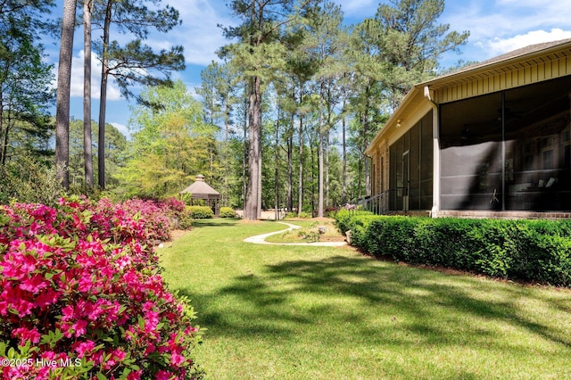view of yard featuring a gazebo and a sunroom
