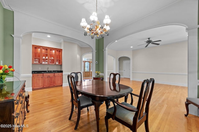 dining room with ceiling fan, arched walkways, light wood-style floors, and recessed lighting