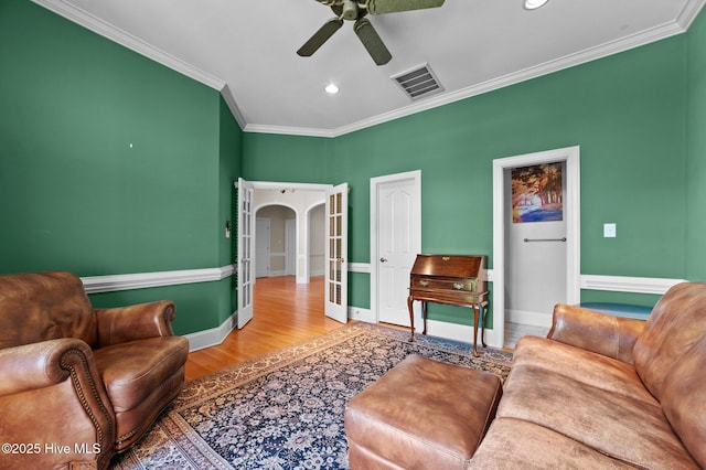 living room featuring recessed lighting, visible vents, a ceiling fan, crown molding, and baseboards