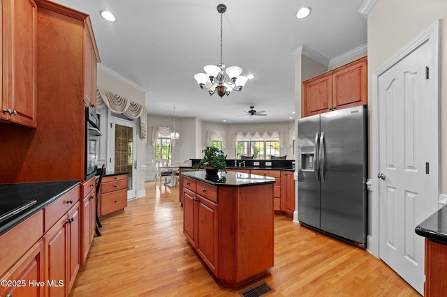 kitchen featuring stainless steel refrigerator with ice dispenser, visible vents, recessed lighting, and dark countertops