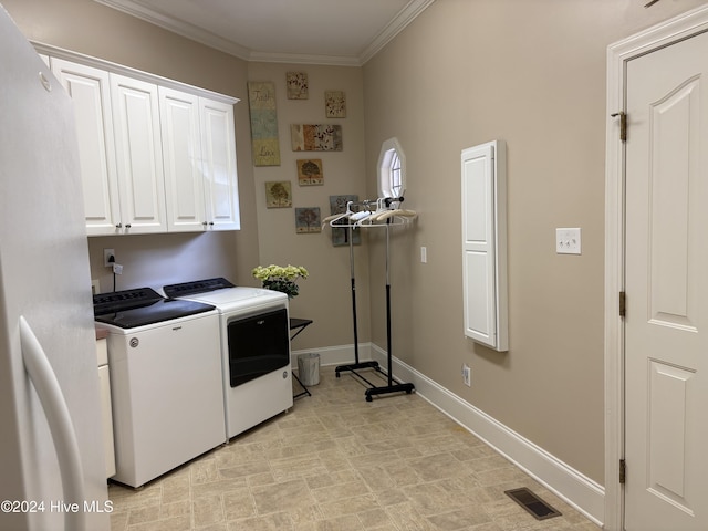 laundry area with separate washer and dryer, crown molding, and cabinets