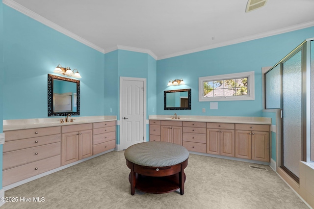 full bathroom with two vanities, a sink, a shower stall, and crown molding