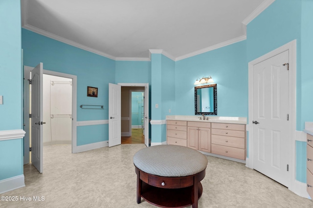 bedroom featuring light floors, baseboards, ornamental molding, and a sink