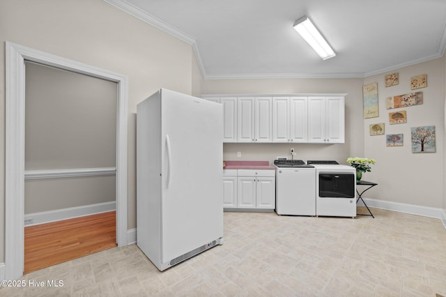 clothes washing area with baseboards, washer and clothes dryer, ornamental molding, and cabinet space
