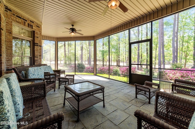 sunroom with ceiling fan and outdoor lounge area
