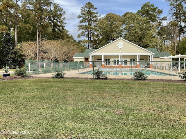 community pool with a lawn and fence