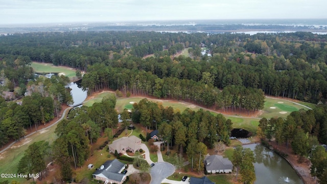 aerial view featuring golf course view, a water view, and a view of trees