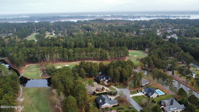 aerial view with a forest view, a residential view, a water view, and golf course view
