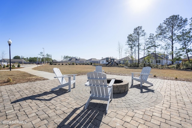 view of patio with a residential view and an outdoor fire pit