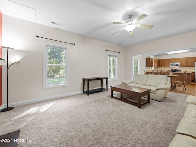 living room with light carpet and ceiling fan