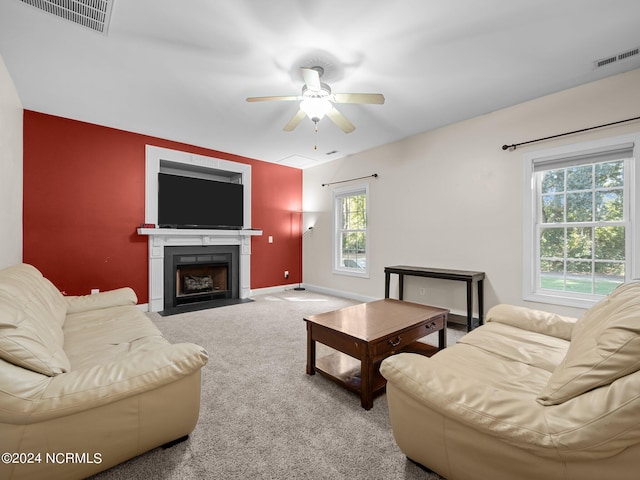 living room featuring ceiling fan, plenty of natural light, and carpet floors