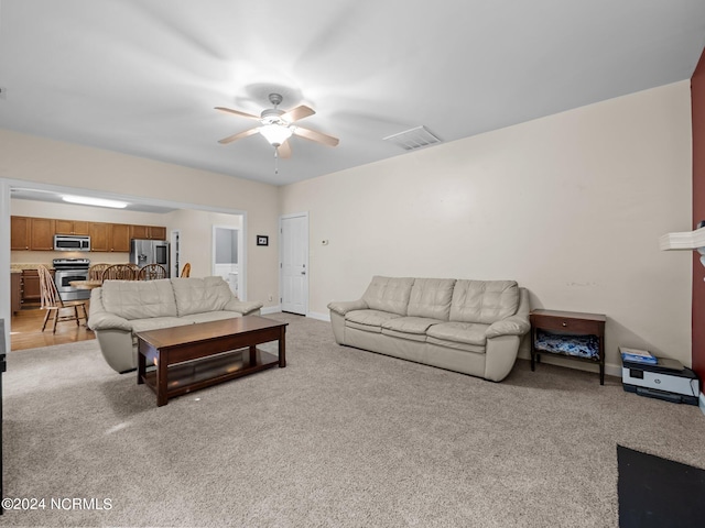 living room featuring light colored carpet and ceiling fan