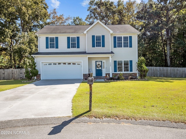 view of front of property with a front yard and a garage