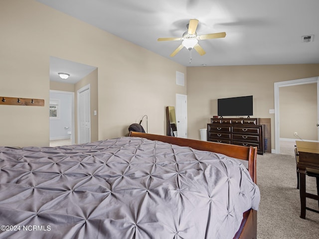 carpeted bedroom featuring ceiling fan, ensuite bathroom, and lofted ceiling