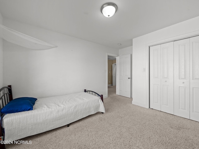 carpeted bedroom with a closet