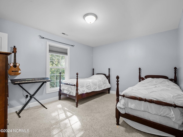 bedroom with light colored carpet