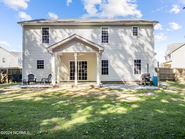 rear view of property with a yard and a patio