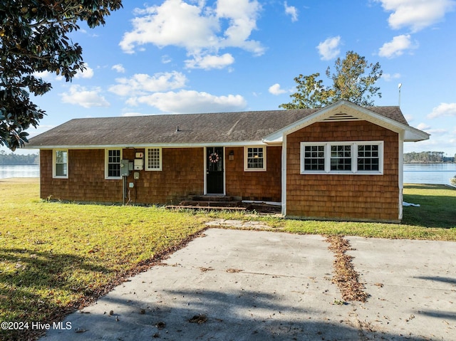 ranch-style home with a water view and a front yard