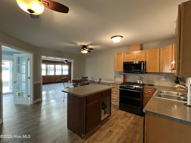 kitchen featuring a healthy amount of sunlight, range with two ovens, a kitchen island, and sink