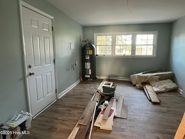 misc room with electric water heater and dark hardwood / wood-style floors