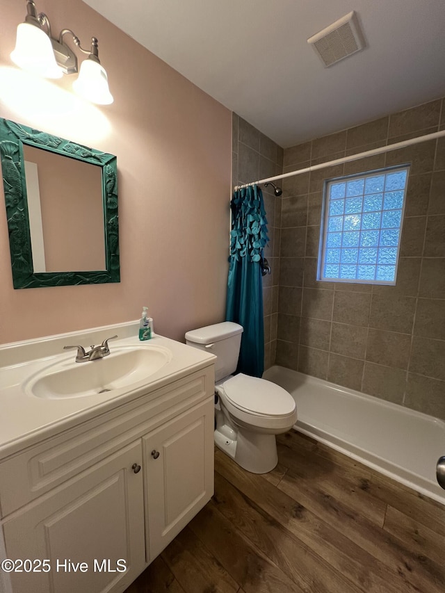 bathroom featuring a shower with curtain, hardwood / wood-style floors, vanity, and toilet