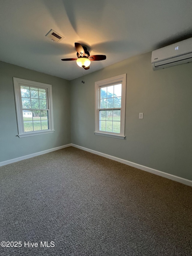 empty room with carpet, a wall unit AC, and ceiling fan