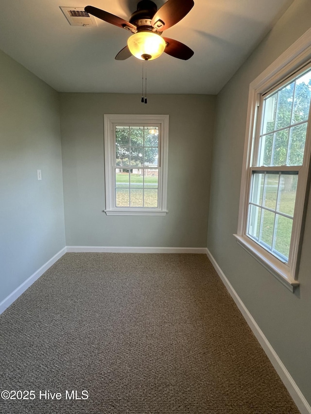 spare room featuring carpet flooring and ceiling fan