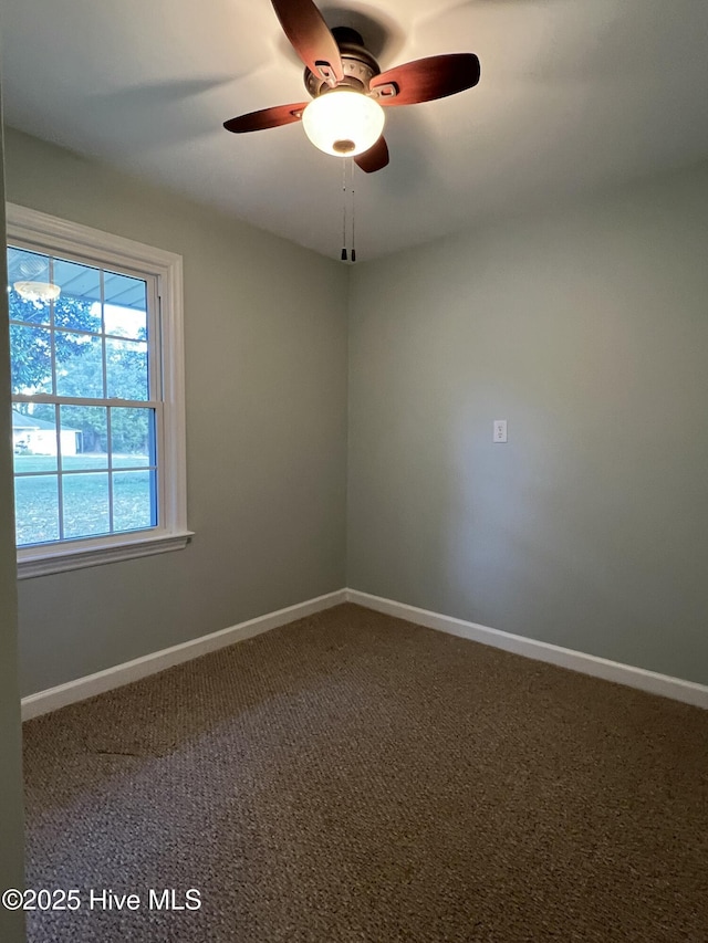 carpeted empty room featuring ceiling fan