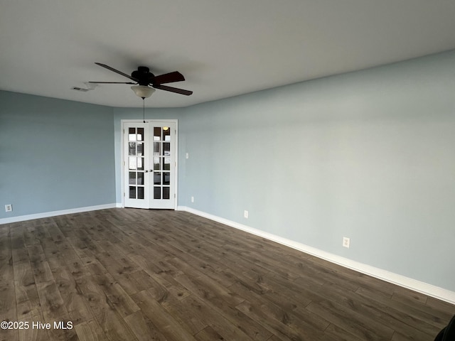 empty room featuring french doors, dark hardwood / wood-style floors, and ceiling fan