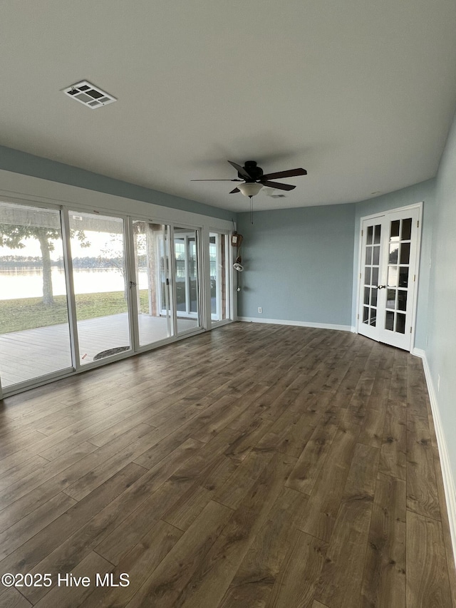 interior space with ceiling fan, french doors, and dark wood-type flooring