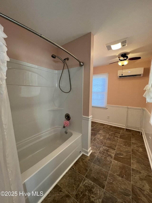 bathroom featuring shower / bath combination with curtain, an AC wall unit, and ceiling fan